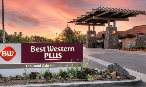 Hotel entrance sign for Best Western Plus Thousand Oaks Inn during sunset.