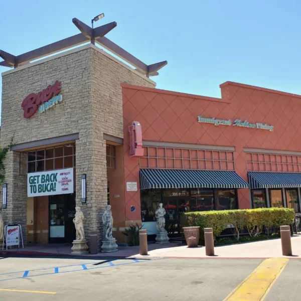 Exterior of Buca di Beppo Thousand Oaks at Janss Marketplace with pink facade, patio, and entrance.