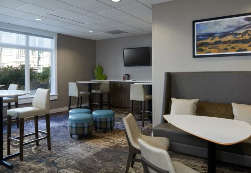 Bright breakfast lounge at Residence Inn Westlake Village featuring high tables and soft neutral décor.