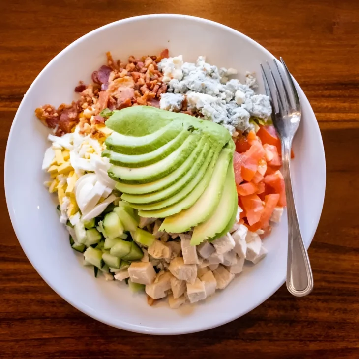 pickles-deli-avocado-chicken-salad-bowl Fresh avocado chicken salad bowl with bacon, blue cheese, cucumber, tomato, and egg at Pickles Deli