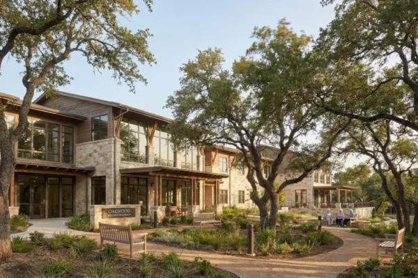 The exterior of Gem Oaks, a premier facility for thousand oaks geriatric care, featuring beautiful oak trees and accessible walking paths for residents.